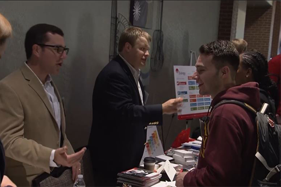 Entergy student interns chatting with employees about the various departments within the company